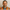 Man wearing an orange safety vest against a plain background